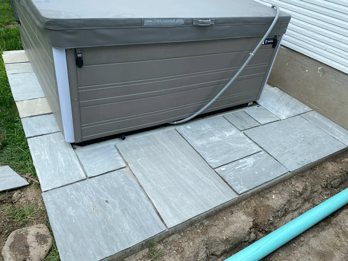 Hot-tub stone pad completed by Queen City Hardscapes