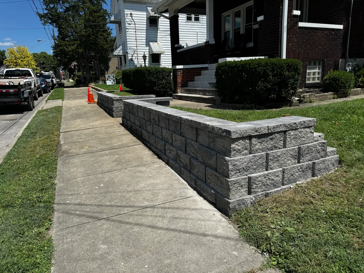 Sidewalk retaining wall completed by Queen City Hardscapes